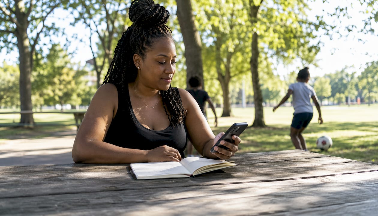 Woman testing site speed on mobile phone outdoors