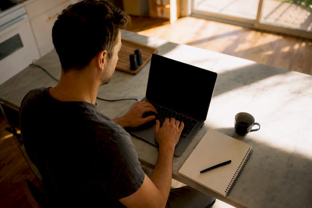 Hands adjusting website builder on laptop