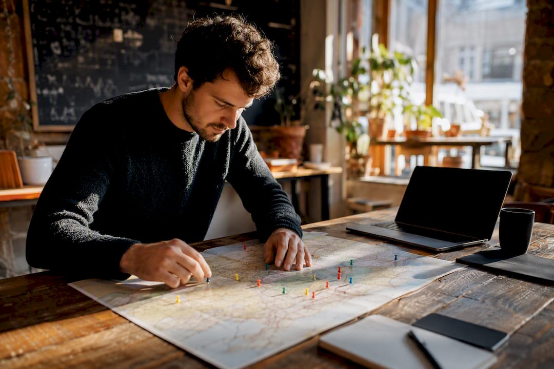 Hands positioning geographic location markers